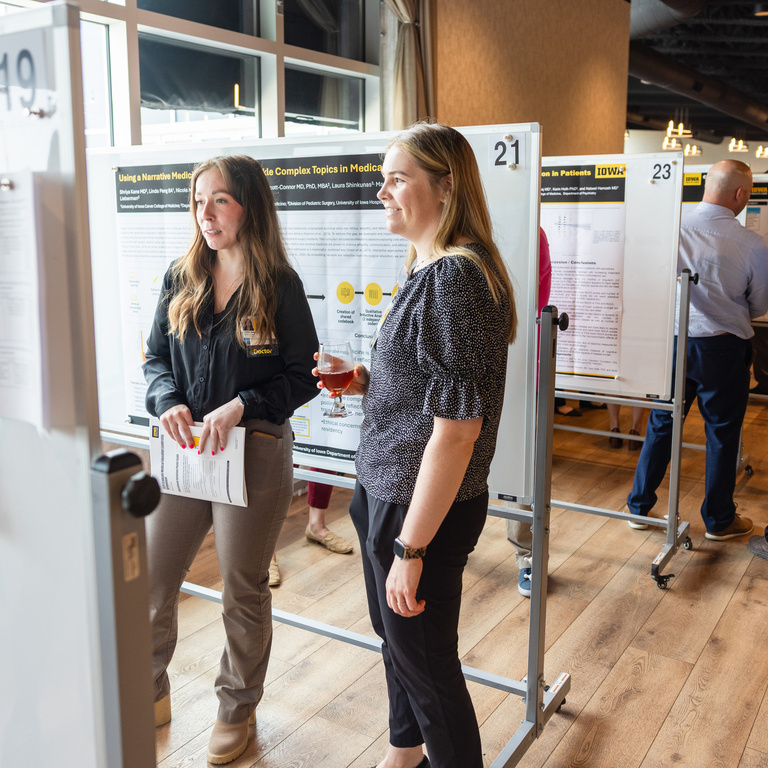 photo of two people looking at a poster at the innovation poster session