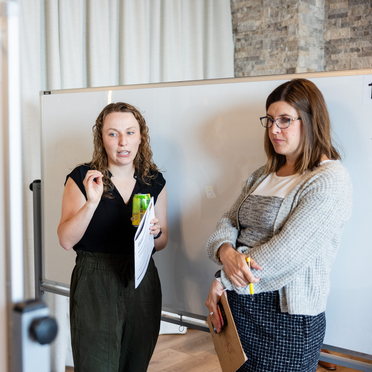 photo of two people discussed a poster at the innovation poster session