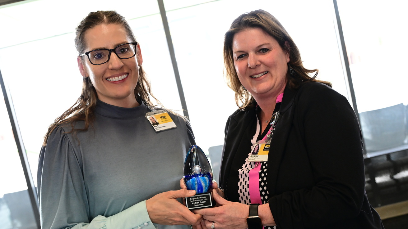 Residency Program Coordinator of the Year, Kate Scheer from Dermatology, receives her award from PC Collab president Cari Harland. 